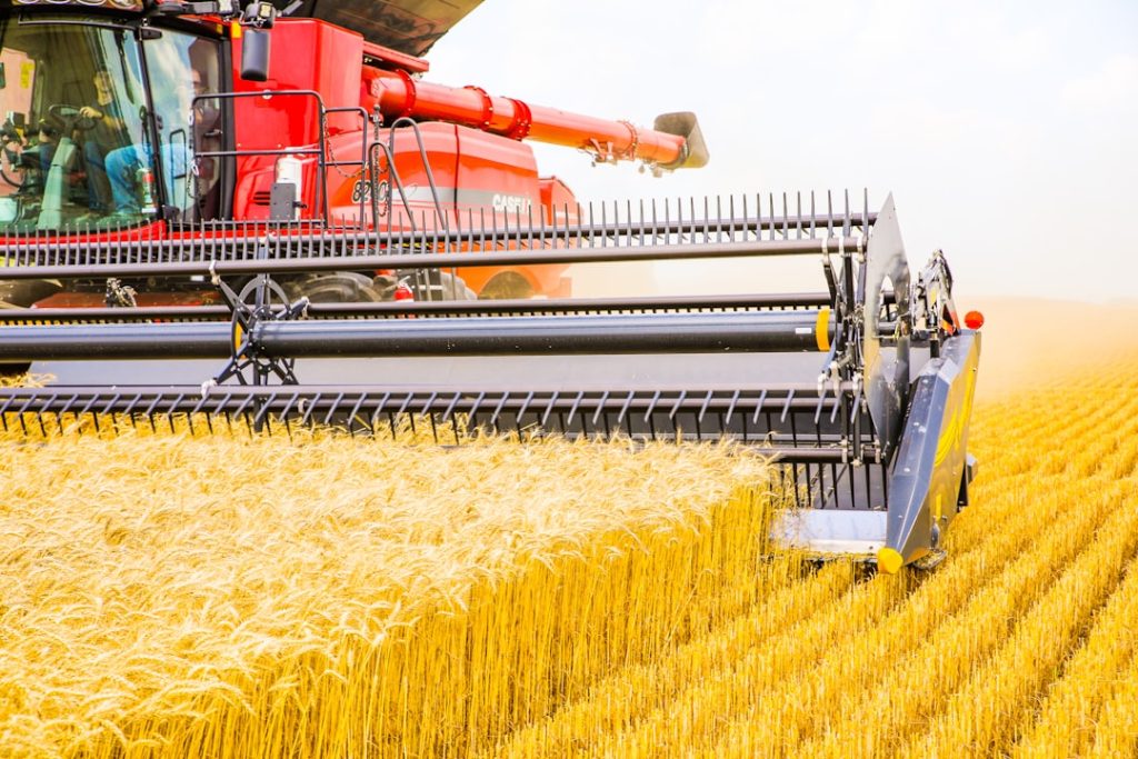 a-combine-of-grain-being-harvested-in-a-field-snntzezrq3a